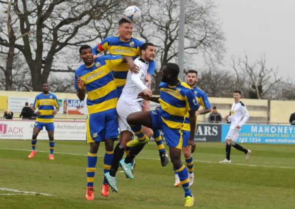 Delroy Gordon finds himself outnumbered by three Solihull Moors defenders, with Liam Daly rising highest to get his head to the centre. Picture: Morris Troughton