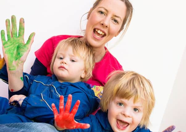 Jo Booth, who set up Arty Splats,  having some messy-play fun with her sons  Finley, aged 18 months (left), and Harry, aged three.