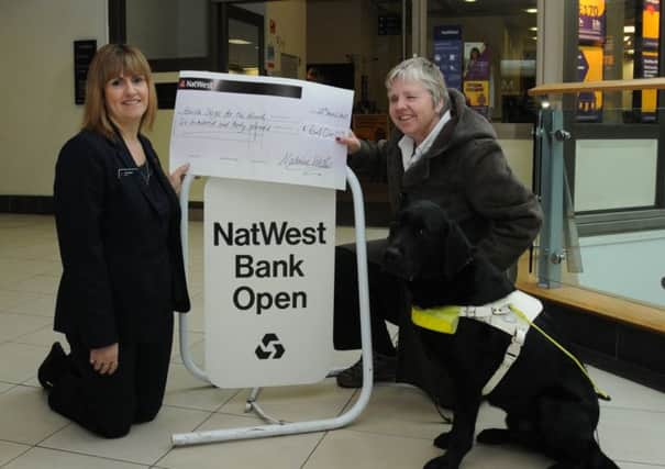 Maggie Bowes and her guide dog Yuan with NatWest manager Janet Gilbert. The branches have raised £640 for her London Marathon attempt.