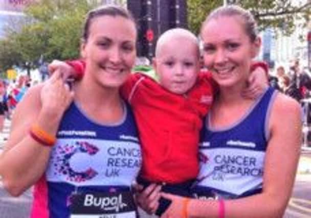 Kelly Sibley (left) and Laura Snow (right) of RunTeamFlo with Kelly's niece Flo Unsworth.