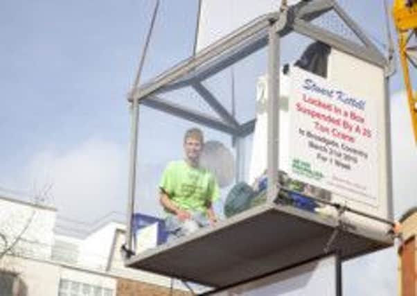 Stuart Kettell suspended in a glass box for a fundraising challenge in 2010. Photo courtesy of Victoria Jane Photography.