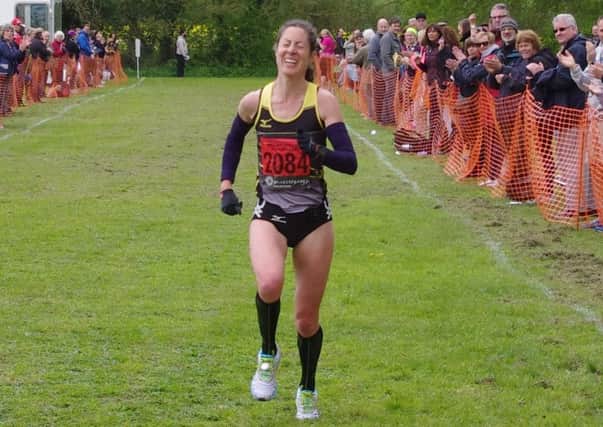 The strain shows on Sue Harrison's face as she approaches the finish line. Picture submitted