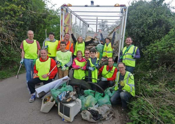 Event organisers Jo Dagg (WDC community partnership team) and Angela Owen sitting on the tailgate of the Neighbourhood Services lorry with fellow litter pickers. NNL-150425-185445009