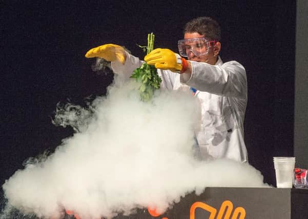 Michael Goble from the Ministry of Science puts some flowers into liquid nitrogen on stage.
