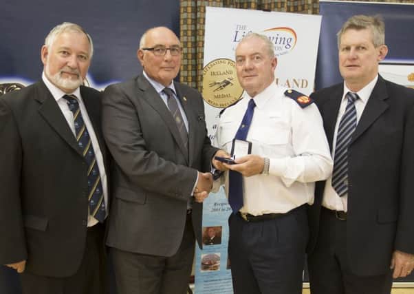 Ireland's Assistant Police Commissioner Jack Nolan presents the Ireland Medal to John Long. Also in the picture are John Connolly, CEO of the Lifesaving Foundation, and Brendan Donohue, chairman of the foundation.
