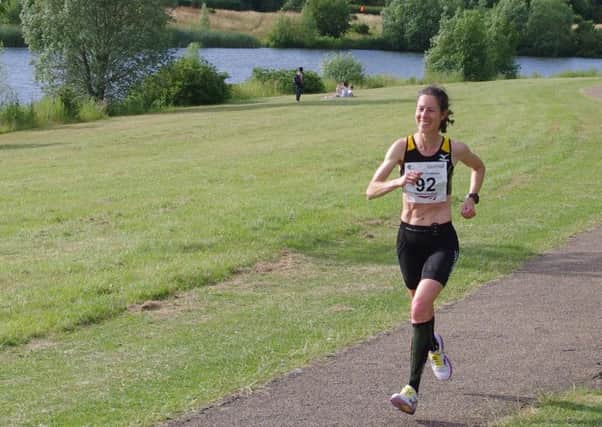 Sue Harrison on her way to overall victory at Caldecotte Lake.