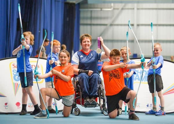 Paralympian Mel Clarke is pictured with pupils from Warton Nethersoles Primary near Tamworth and Milverton Primary Schools Lucy Green and Shay Beale (orange tops). Picture submitted
