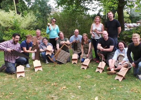 Students on the furniture crafts course at Warwickshire College with their woodworks.