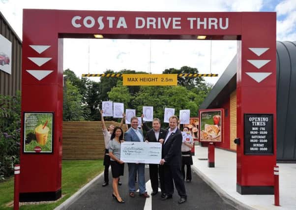 Steve Falle and Winx Falle of WY & SF Ltd and The Costa Management Team including head members of the Costa Foundation open the new Costa Coffee drive thu in Leamington.