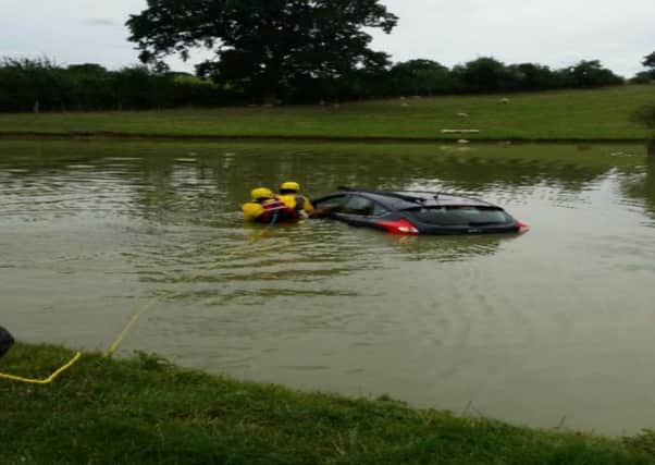 An 80-year-old man was so calm he sat smoking his pipe while his car filled up with water after it had ended up in a lake in Loxley. Photograph courtesy of West Midlands Ambulance Service.