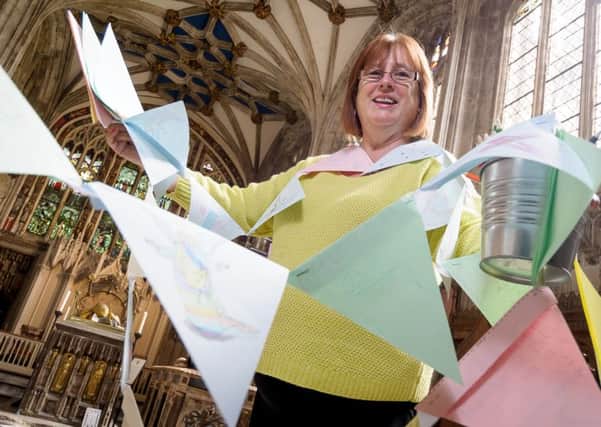 Visitors are being offered the opportunity to help complete a bunting display, celebrating the work at the church.

Pictured: Alice Pethick (Project Coordinator). NNL-151108-234406009