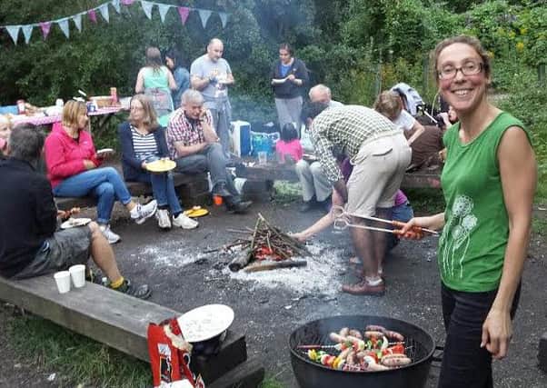 Kristie Naimo, chairman of the Friends of Foundry Wood, cooks up some barbecue food for supporters of the venture.