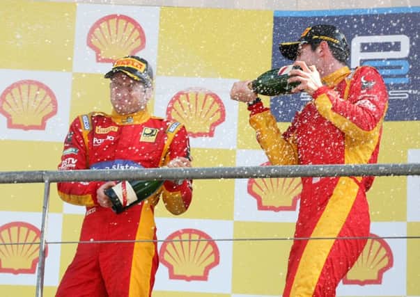 Jordan King is sprayed with champagne by his Racing Engineering team-mate Alexander Rossi.