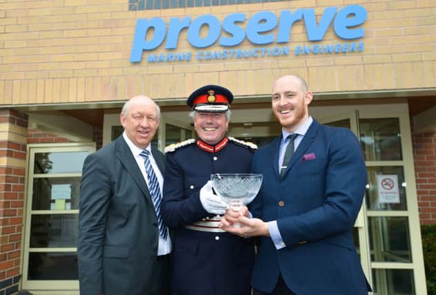 From left to right: Martin Hawkswood, Lord Lt of Warwickshire Timothy Cox, and James Hawkswood with the Queens Award for Enterprise in the Innovation category