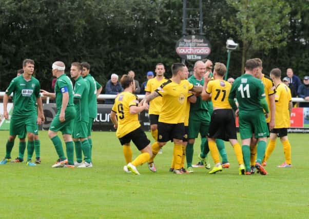 Tensions rise after Will Green goes down on the edge of the Bedworth box. Pictures: Morris Troughton