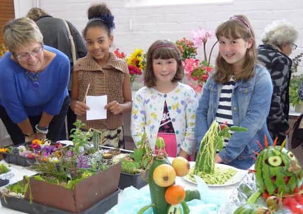 Paula Kerr of the Wellesbourne and Walton Horticultural Show committee with young entrants Ruby Caines, Lucy Aiello and Eleanor Aiello.