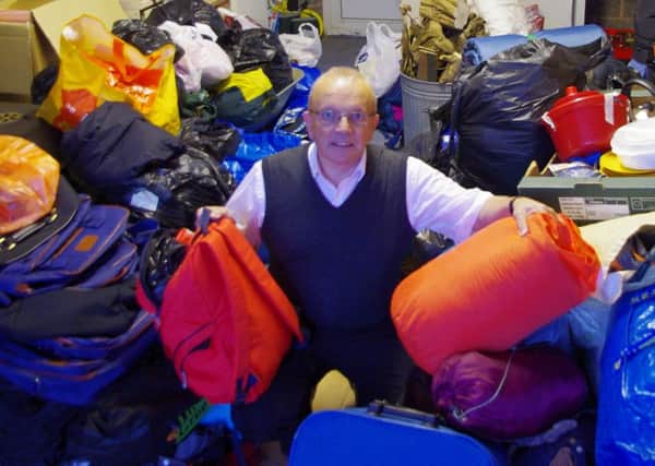 Richard Dickson surrounded by donated items