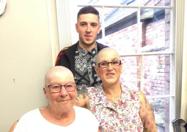 Sue Moroney and Linda March had their heads shaved for charity. Pictures is Jordon, Sue's son who chopped their locks at Razor Varbers Shop in Leamington.