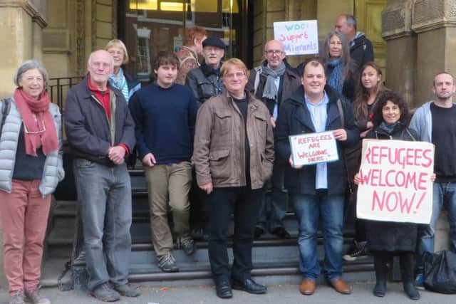 Labour party members including Jerry Weber (fourth from left) and campaigners protest for more support for refugees.