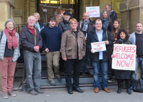 Labour party members including Jerry Weber (fourth from left) and campaigners protest for more support for refugees.