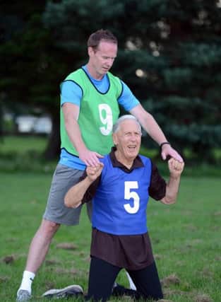 Mike Collins of British Military Fitness puts a pensioner through his paces.