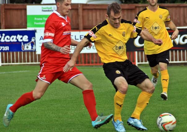 Lee Chilton shields the ball from Frome's Ricky Hulbert. Picture: Sally Ellis