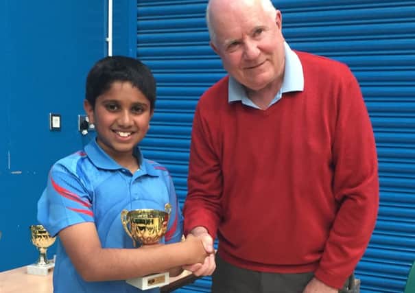 Nikit Sajiv is presented with his trophy after winning his age group at the West Midlands 2-star junior tournament.