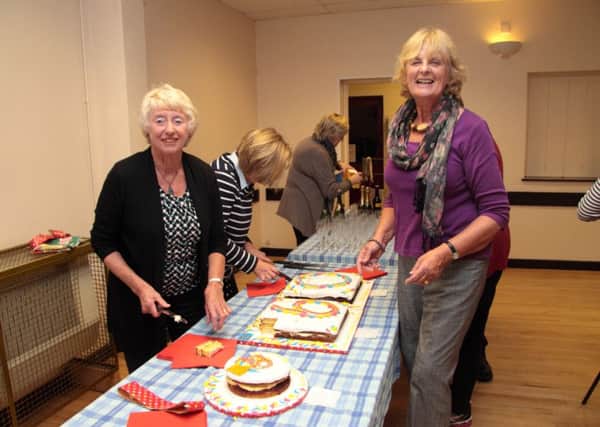 Rona Taylor, Faith Ward and Diane Swindells divide the celebration cake