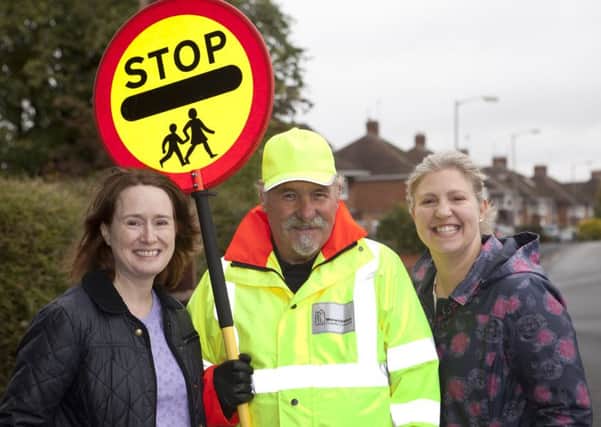 Amy Ashby and Anne Buttrum with lollipop man George Hamilton.