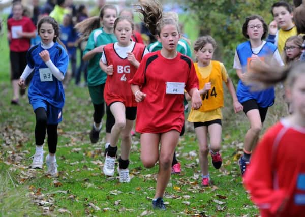 Runners make sure of their footing during the first lap of the girls race. Pictures: Morris Troughton