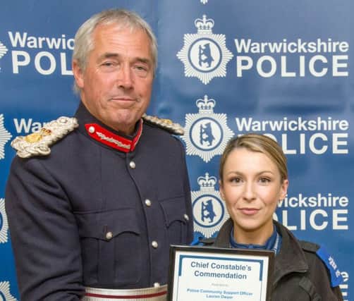 PCSO Lauren Dwyer receives her award from Warwickshire Lord Lieutenant Timothy Cox.