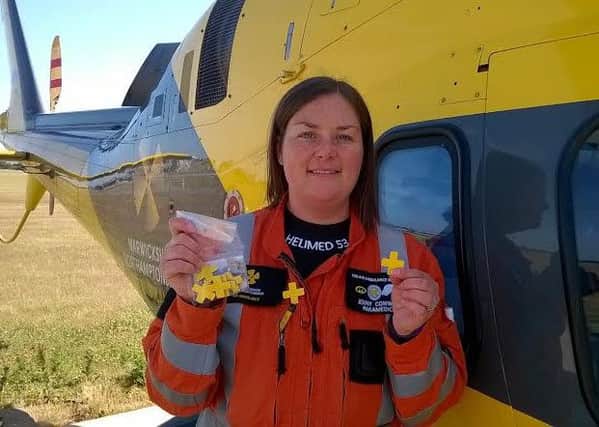 Critical care paramedic Jenny Conway with the yellow pin badges.