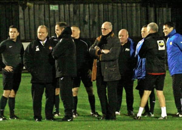 Staff from Rushall and Leamington gather with match officials ahead of Tuesday night's postponement. Picture: Sally Ellis