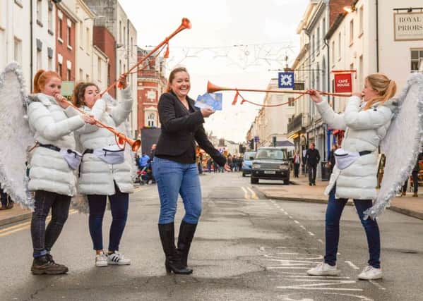 Stephanie Kerr, executive director of BID Leamington, wiht three of the parking angels.