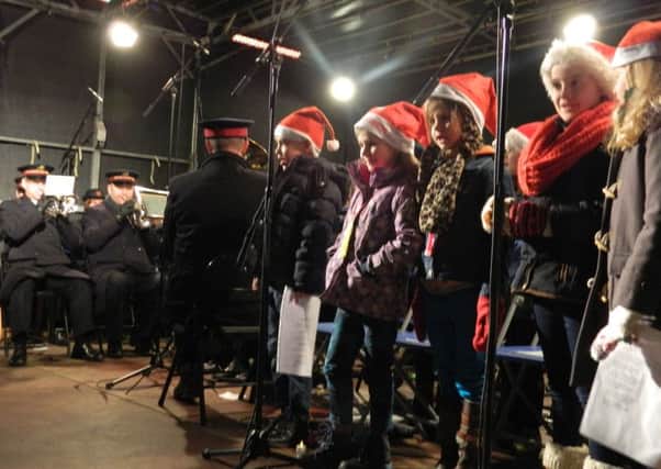 Young singers and the Salvation Army Band at last year's Carols in the Castle
