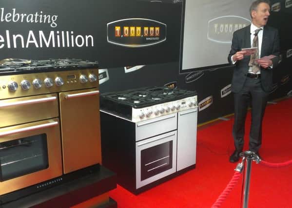 William McGrath, chief executive of the AGA Rangemaster Group, delivers his speech during the unveiling of the company's one millionth range cooker this year. On the far left is the golden Nexus 90  and closest to Mr McGrath is a special commemorative cake made for the occasion. NNL-150528-111947001