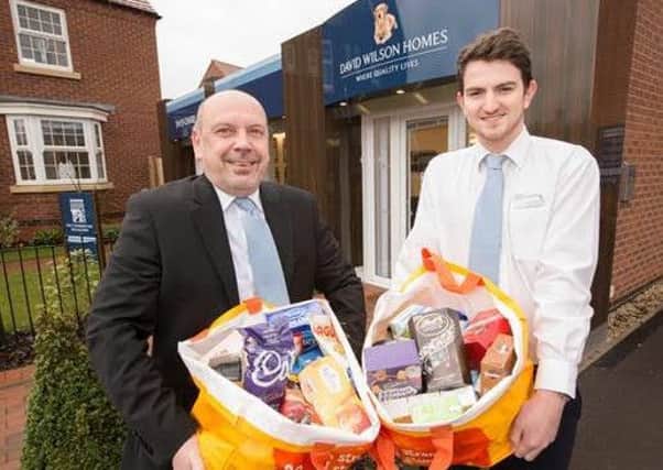 Gavin Pole and Shane Sims of David Wilson Homes prepare the food collected to donate to the Trussell Trust.