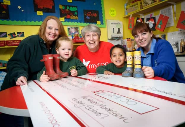 Yvonne Hamill, Anita Burrows (Community Fundraiser - Myton Hospice), and Beth Wilkins with pupils at Rugby Montessori Nursery School