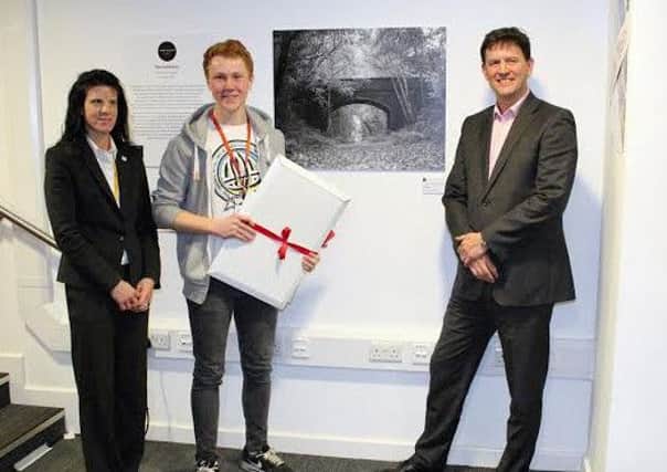 Jack Bennett is presented with his prize by Angela Joyce, Warwickshire College group principal and Duncan Midwood, managing director of Cewe UK.