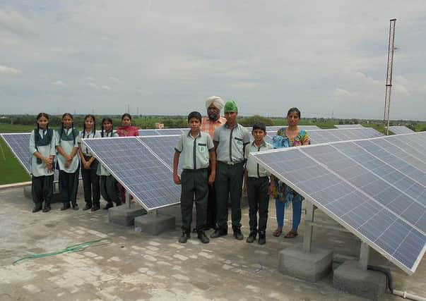 Pupils at the Gilly Mundy Memorial Community School in India with the school's new solar panels.