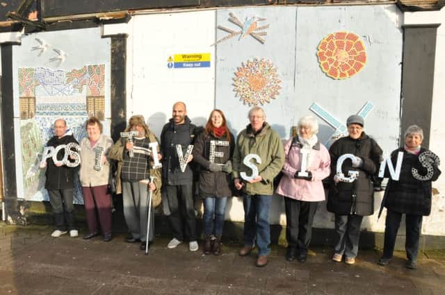 The Postive Signs mosaic group stands by its work at the former Stoneleigh Arms pub in Clemens Street, Old Town.