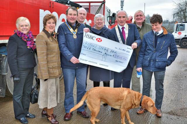 Melbros presents the cheque to the Rotary Clubs of Rugby