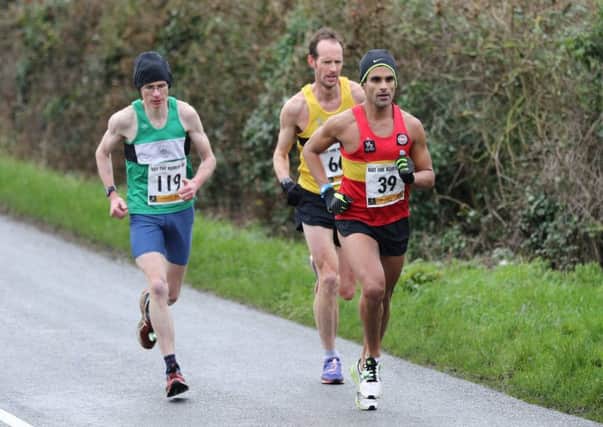 Kenilworth Runners' Connor Carson battles it out with Richard Shephard and Namir Batavia. Picture: Tim Nunan