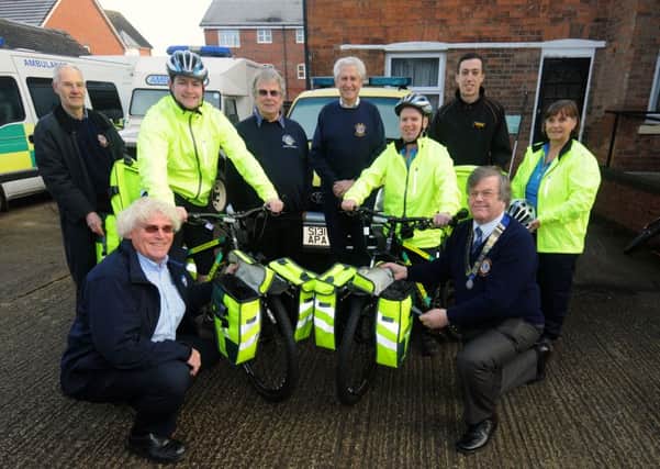 Mike Cornes (kneeling), Chairman and co-ordinater of Warwick Ambulance Association thanks Warwick Lions Club President David Shore. Also pictured are cycle response unit members Tim Harrison, Adam Leahy and Barbara Cornes, Lions Geoff Wiskin, Neil Chisholm and Norman Winnett plus Warren Insley from Halfords. NNL-160117-150758009