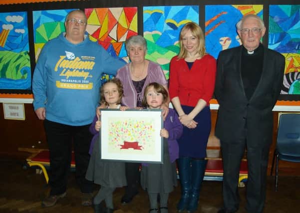 Pictured are (back row from left to right) George Pearson, Christine Pearson, Jo Howell (school head) and Father Laurence Crowe. In front from left to right, Layla Hudson and Tillie Hudson (Christine and George's grand daughters who are pupils at the school).