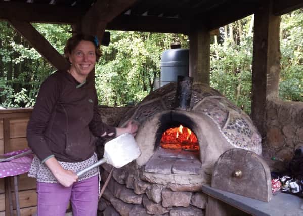 Kath Pasteur of the Friends of Foundry Wood bakes fresh pizza in the wood's pizza oven.