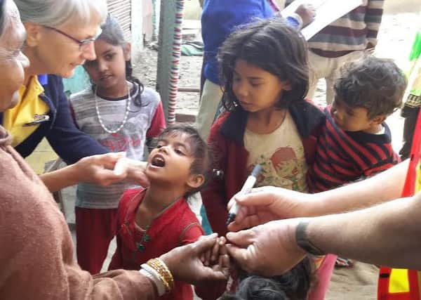 Rosemary Good and May Shaker vaccinating children againt polio in India.