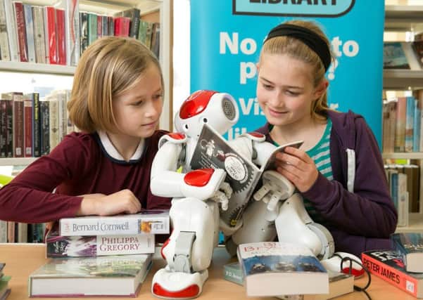 Evie and Esme with robot NAO at the launch of Southam's new library. Picture by Dave Warren.