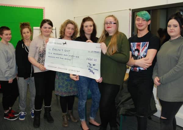Warwickshire College Students present Helen Smith, founder of the charity Evelyns Gift, with a cheque for Â£650.