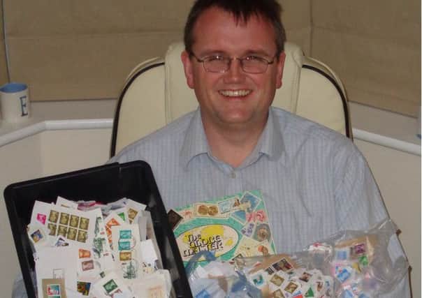 Bishop Jonathan Maxwell with a selection of stamps that have been donated to the appeal